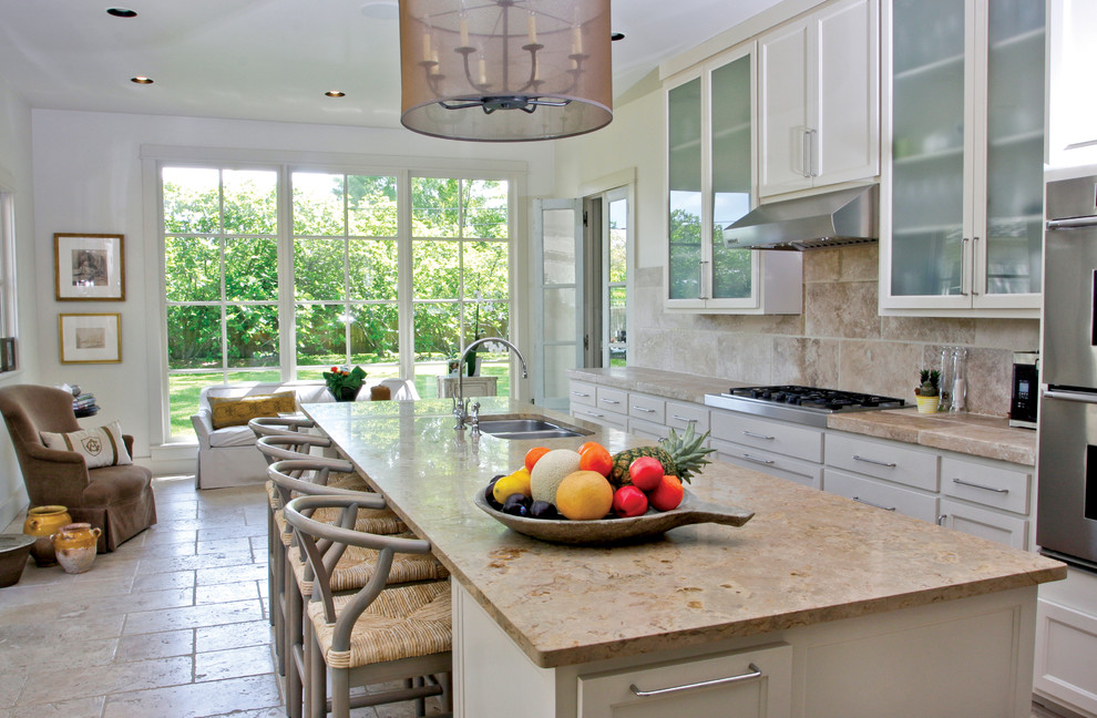 Example of a trendy kitchen design in New Orleans with limestone countertops and limestone backsplash