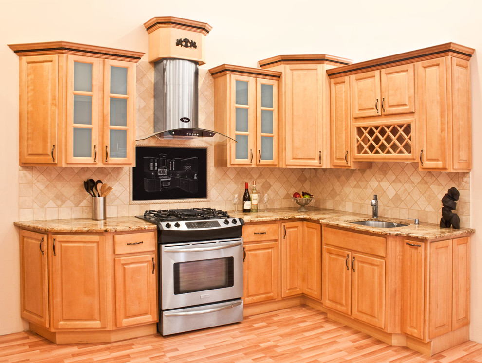 Example of a mid-sized classic l-shaped light wood floor enclosed kitchen design in Philadelphia with an undermount sink, raised-panel cabinets, medium tone wood cabinets, granite countertops, beige backsplash, ceramic backsplash, stainless steel appliances and no island