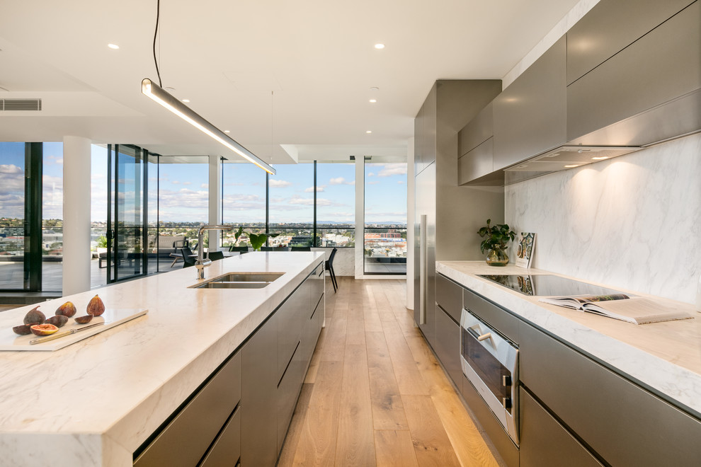 Photo of a medium sized contemporary galley open plan kitchen in Melbourne with a double-bowl sink, grey cabinets, marble worktops, multi-coloured splashback, marble splashback, stainless steel appliances and an island.