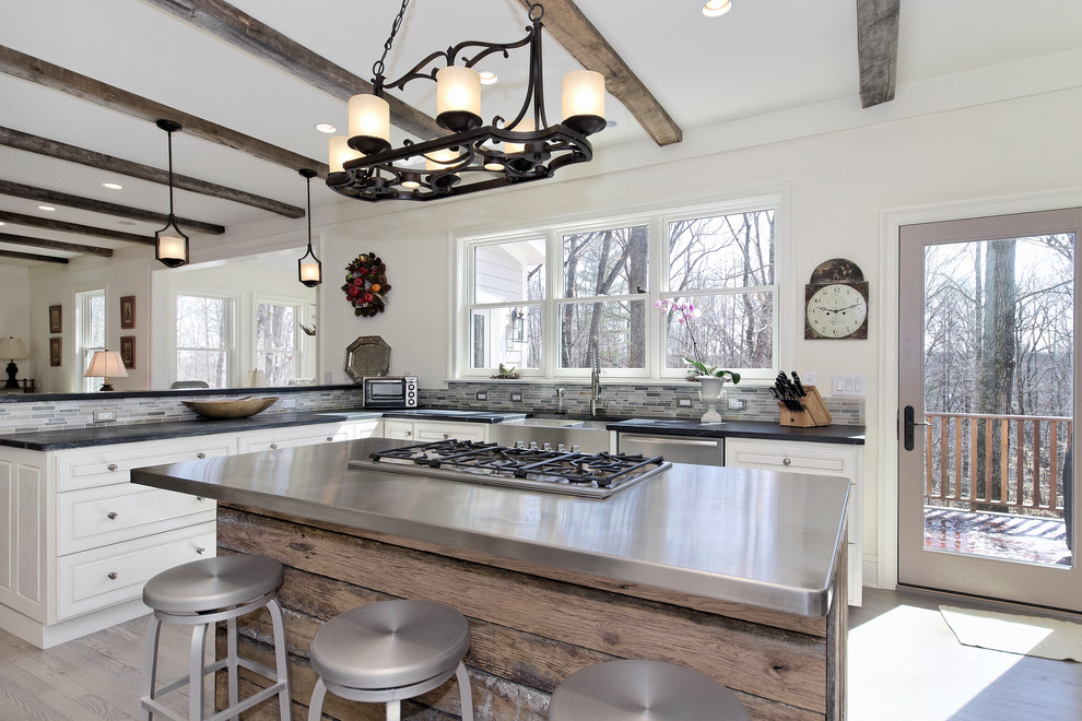 Example of a transitional u-shaped open concept kitchen design in Other with a farmhouse sink, raised-panel cabinets, white cabinets and soapstone countertops
