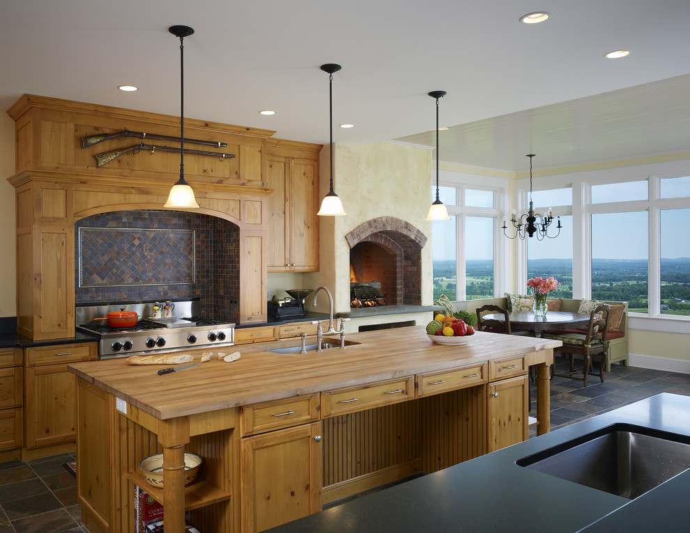 Example of a farmhouse kitchen design in DC Metro with wood countertops