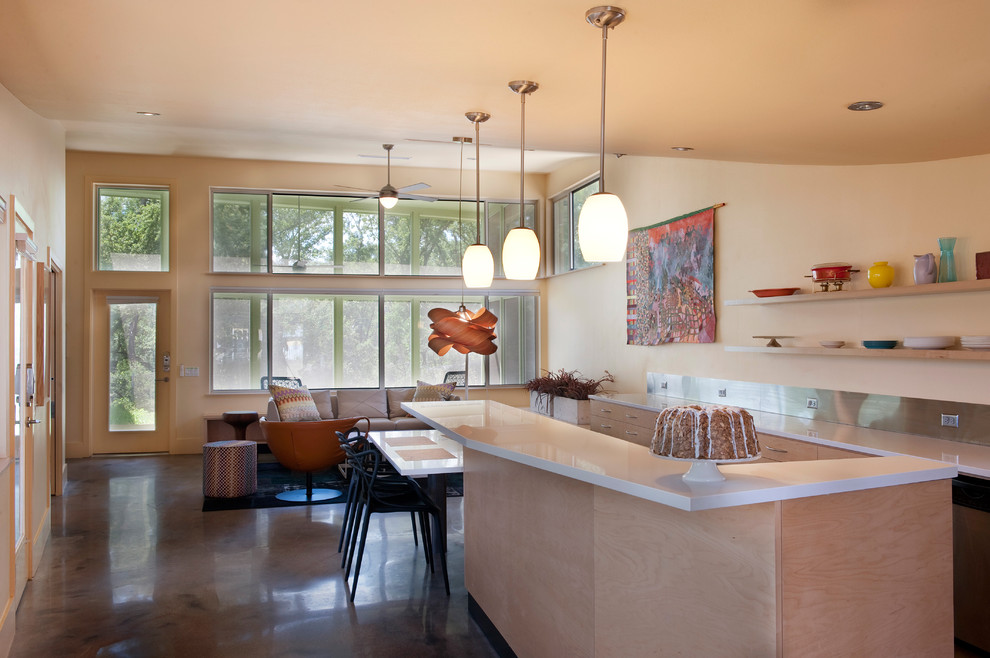 Open concept kitchen - mid-sized contemporary galley concrete floor open concept kitchen idea in Austin with flat-panel cabinets, light wood cabinets, metallic backsplash, a double-bowl sink, quartz countertops, stainless steel appliances and an island