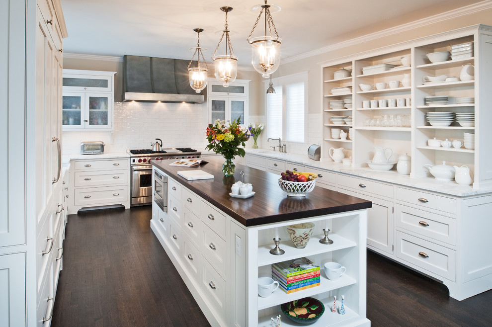 Inspiration for a mid-sized timeless u-shaped dark wood floor eat-in kitchen remodel in New York with beaded inset cabinets, white cabinets, marble countertops, white backsplash, subway tile backsplash, stainless steel appliances, an island and an undermount sink