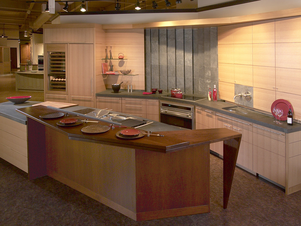 Example of a mid-sized asian galley linoleum floor eat-in kitchen design in Boston with an undermount sink, flat-panel cabinets, light wood cabinets, concrete countertops, gray backsplash, cement tile backsplash, stainless steel appliances and an island