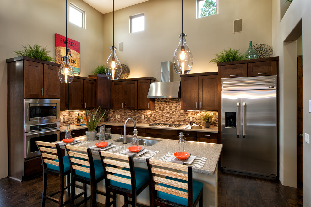 Classic kitchen in Phoenix with a double-bowl sink, shaker cabinets, dark wood cabinets, brown splashback, matchstick tiled splashback and stainless steel appliances.