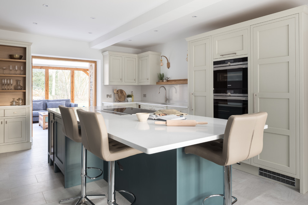 Medium sized traditional l-shaped enclosed kitchen in Other with shaker cabinets, quartz worktops, white splashback, stone slab splashback, integrated appliances, an island, grey floors, white worktops and beige cabinets.