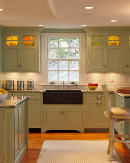 Sage green kitchen with shaker cabinets in a renovated 1880s house