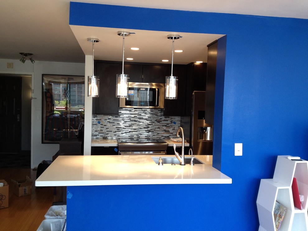 Example of a mid-sized trendy galley bamboo floor eat-in kitchen design in New York with an undermount sink, flat-panel cabinets, brown cabinets, quartz countertops, metallic backsplash, mosaic tile backsplash, stainless steel appliances and a peninsula