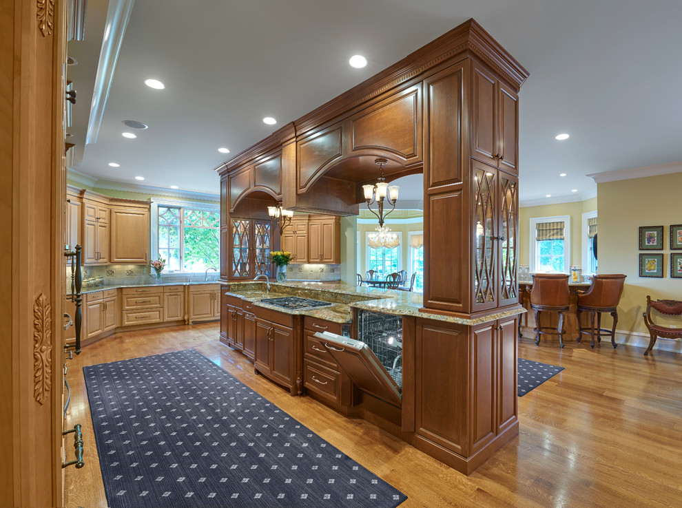 Photo of an expansive traditional l-shaped open plan kitchen in Louisville with a submerged sink, raised-panel cabinets, medium wood cabinets, granite worktops, beige splashback, ceramic splashback, integrated appliances, medium hardwood flooring and an island.