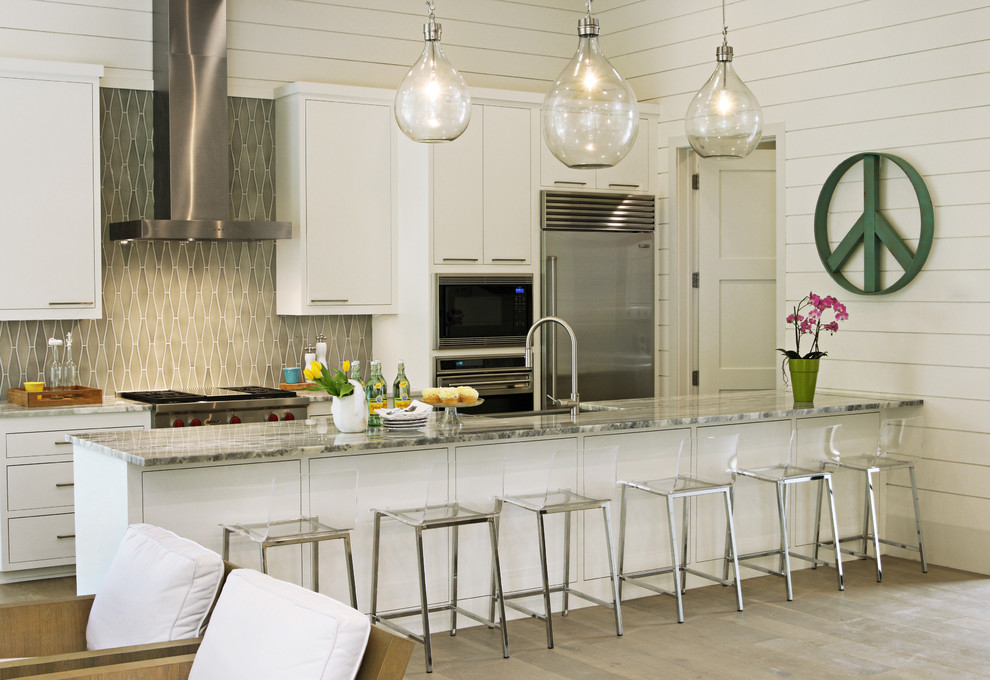 Example of a trendy galley kitchen design in Austin with gray backsplash and a peninsula