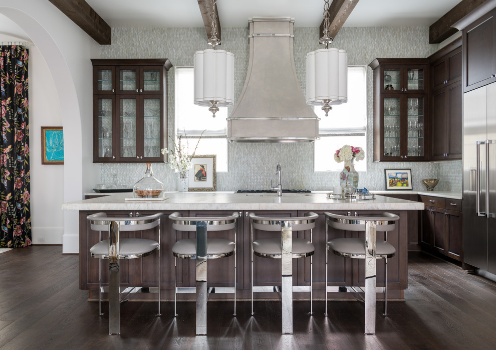 Example of a large transitional l-shaped dark wood floor and brown floor open concept kitchen design in Other with an undermount sink, shaker cabinets, dark wood cabinets, quartzite countertops, white backsplash, glass tile backsplash, stainless steel appliances, an island and beige countertops