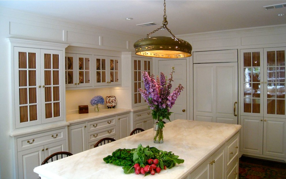 This is an example of a traditional kitchen in Houston with marble worktops.