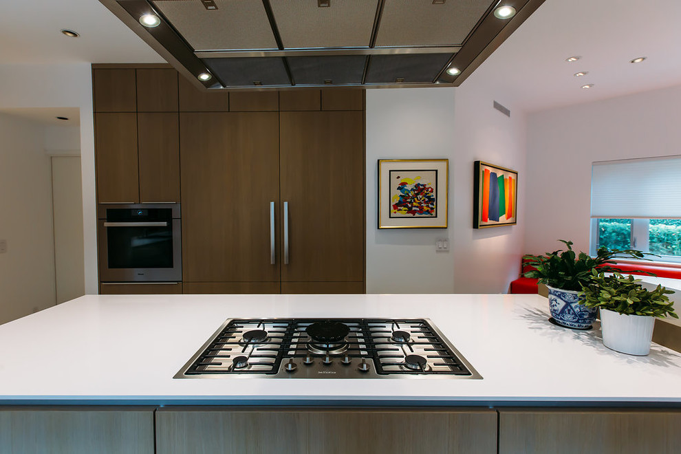 Immagine di un grande cucina con isola centrale chic chiuso con ante lisce, ante grigie, top in quarzo composito e paraspruzzi grigio