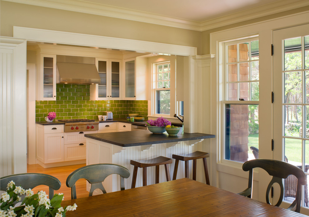 Rustic kitchen in Boston with glass-front cabinets, metro tiled splashback, white cabinets and green splashback.