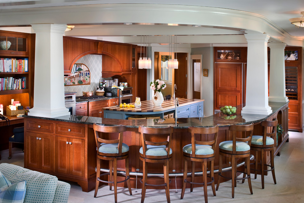 Example of a mid-sized classic u-shaped marble floor eat-in kitchen design in Boston with an undermount sink, recessed-panel cabinets, medium tone wood cabinets, marble countertops, porcelain backsplash, paneled appliances and a peninsula