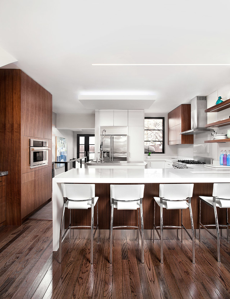 Inspiration for a medium sized contemporary u-shaped kitchen/diner in Toronto with a submerged sink, flat-panel cabinets, medium wood cabinets, engineered stone countertops, white splashback, glass sheet splashback, stainless steel appliances, porcelain flooring and an island.