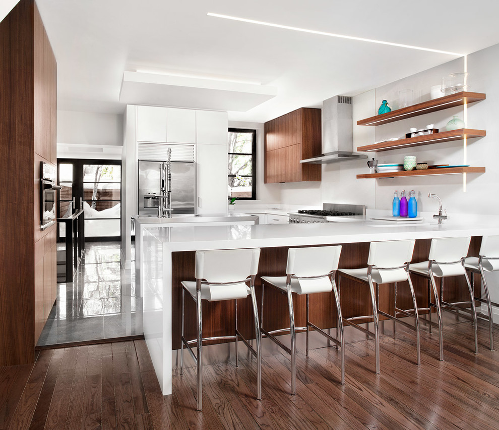 Inspiration for a medium sized contemporary u-shaped kitchen/diner in Toronto with a submerged sink, flat-panel cabinets, medium wood cabinets, engineered stone countertops, white splashback, glass sheet splashback, stainless steel appliances, porcelain flooring and an island.