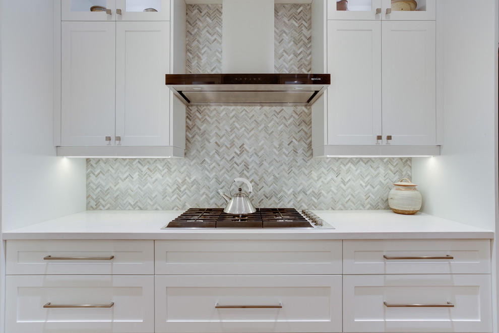 Design ideas for a medium sized traditional galley kitchen in Toronto with a submerged sink, shaker cabinets, white cabinets, engineered stone countertops, grey splashback, stone tiled splashback, stainless steel appliances, medium hardwood flooring and no island.
