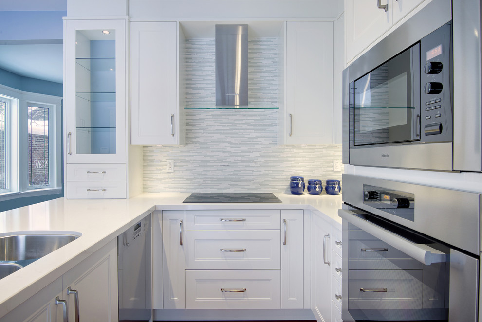 Inspiration for a small victorian u-shaped enclosed kitchen in Toronto with a submerged sink, beaded cabinets, white cabinets, engineered stone countertops, multi-coloured splashback, matchstick tiled splashback, stainless steel appliances, medium hardwood flooring and a breakfast bar.