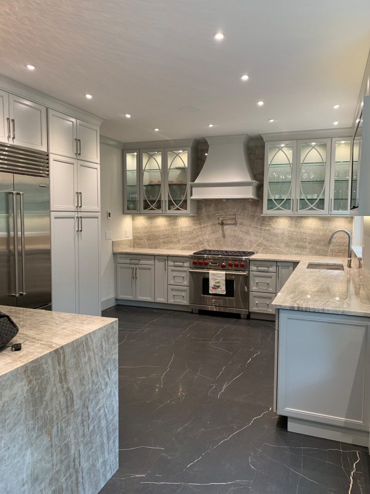 Enclosed kitchen - mid-sized transitional l-shaped marble floor and black floor enclosed kitchen idea in New York with an undermount sink, flat-panel cabinets, gray cabinets, quartzite countertops, beige backsplash, stone slab backsplash, stainless steel appliances, a peninsula and beige countertops