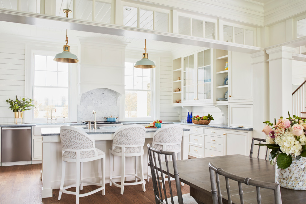 Eat-in kitchen - cottage u-shaped medium tone wood floor and brown floor eat-in kitchen idea in Richmond with a farmhouse sink, recessed-panel cabinets, white cabinets, soapstone countertops, white backsplash, marble backsplash, stainless steel appliances, an island and gray countertops