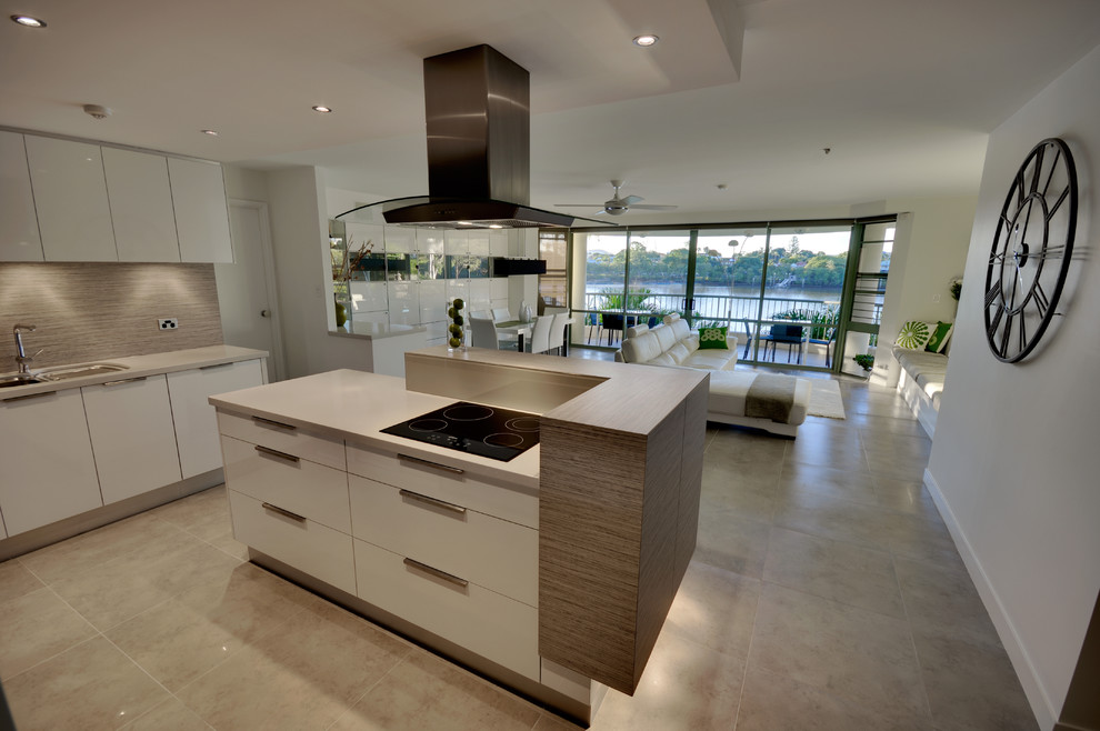 Design ideas for a contemporary open plan kitchen in Brisbane with a submerged sink, flat-panel cabinets, white cabinets, beige splashback and black appliances.