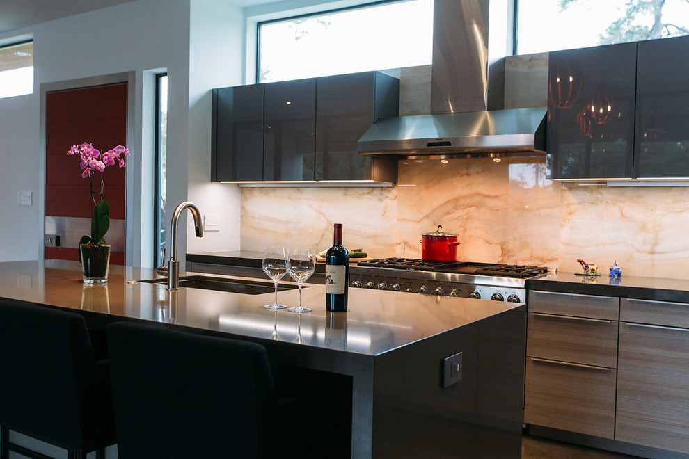 Foto di una cucina moderna di medie dimensioni con lavello sottopiano, ante lisce, ante grigie, top in quarzo composito, elettrodomestici da incasso e pavimento in cemento