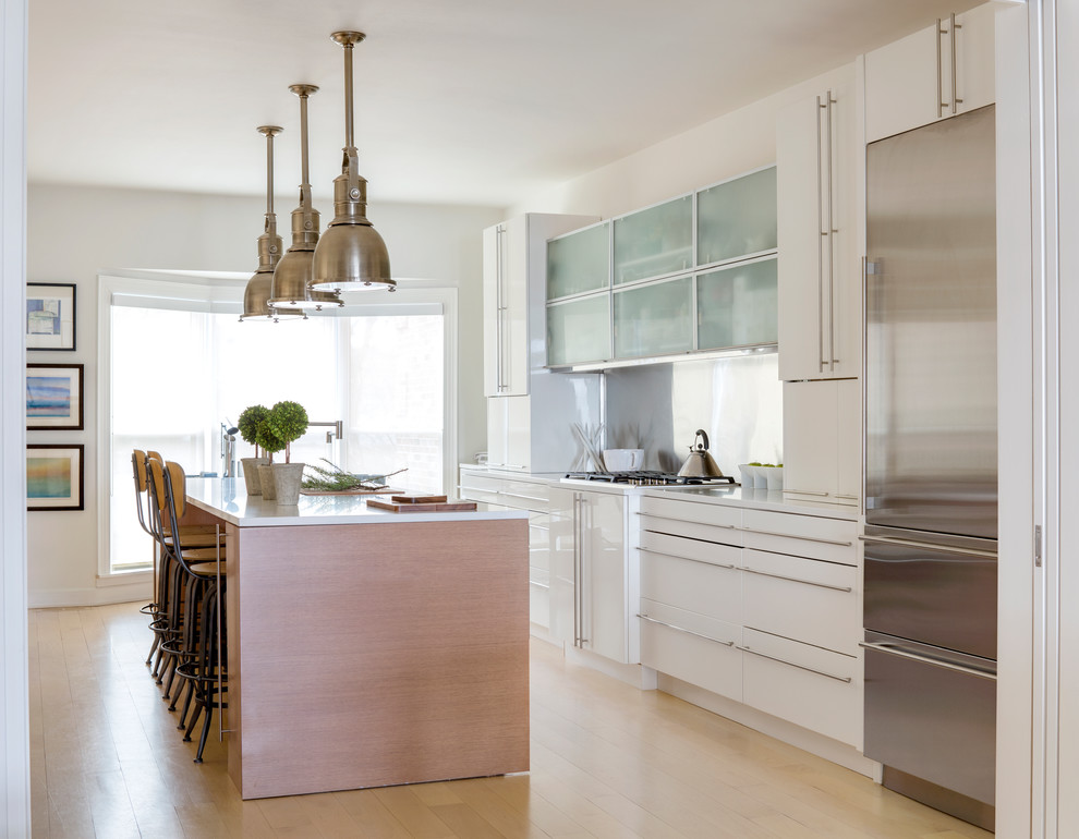 Eat-in kitchen - mid-sized modern galley light wood floor and beige floor eat-in kitchen idea in Chicago with an undermount sink, flat-panel cabinets, white cabinets, quartz countertops, metal backsplash, stainless steel appliances, an island and white countertops
