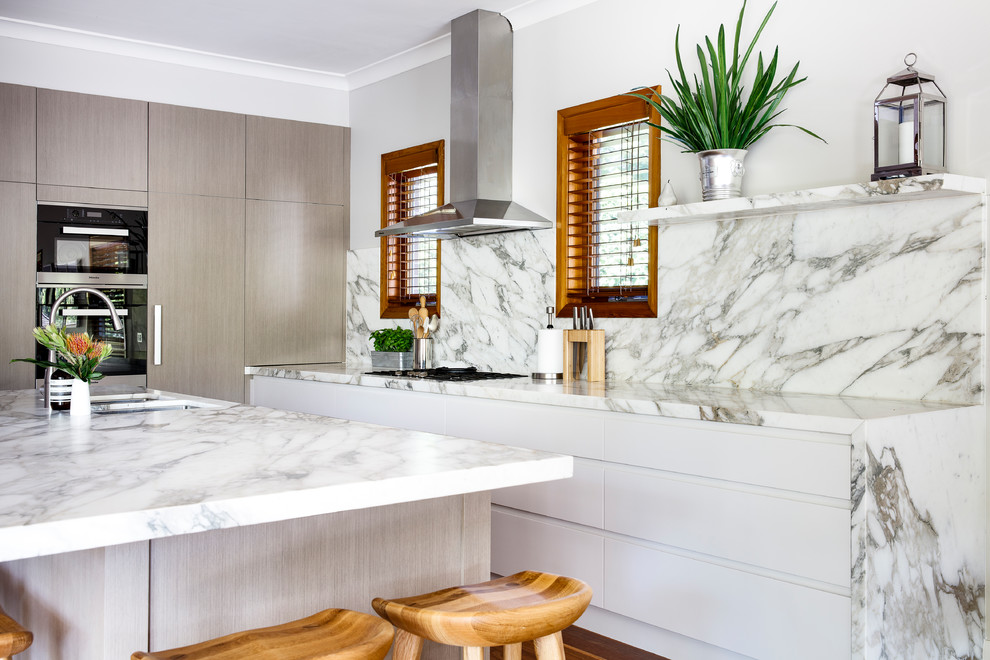 Large traditional l-shaped open plan kitchen in Sydney with a submerged sink, light wood cabinets, marble worktops, multi-coloured splashback, marble splashback, integrated appliances, medium hardwood flooring, an island, multi-coloured floors and multicoloured worktops.