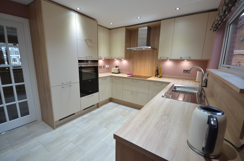 Photo of a medium sized contemporary u-shaped kitchen/diner in Other with laminate countertops, terracotta flooring, no island, a double-bowl sink, shaker cabinets, medium wood cabinets, brown splashback, wood splashback, coloured appliances and white floors.