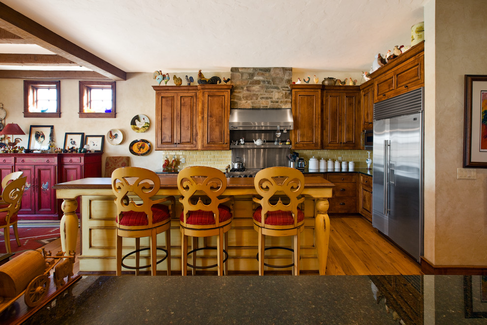 シカゴにあるカントリー風のおしゃれなキッチン (レイズドパネル扉のキャビネット、中間色木目調キャビネット、木材カウンター、黄色いキッチンパネル、サブウェイタイルのキッチンパネル、シルバーの調理設備) の写真