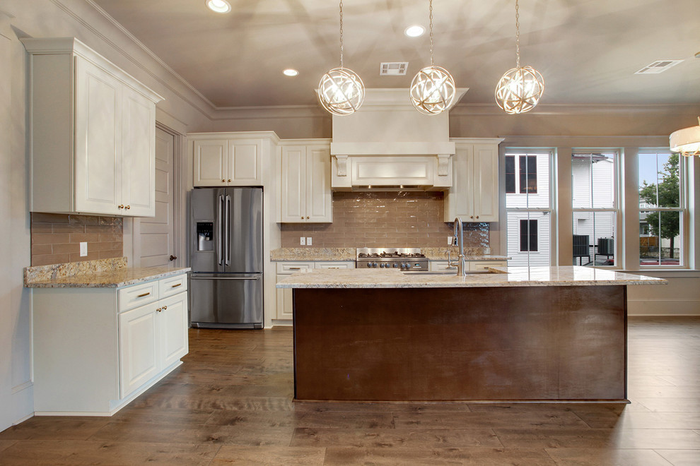 Inspiration for a medium sized traditional l-shaped open plan kitchen in New Orleans with a belfast sink, raised-panel cabinets, white cabinets, beige splashback, stainless steel appliances, medium hardwood flooring and an island.