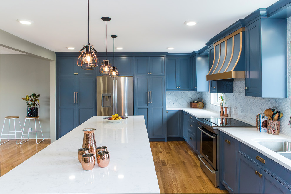 Inspiration for a large transitional l-shaped medium tone wood floor and brown floor enclosed kitchen remodel in Other with a double-bowl sink, recessed-panel cabinets, blue cabinets, marble countertops, white backsplash, marble backsplash, stainless steel appliances and an island