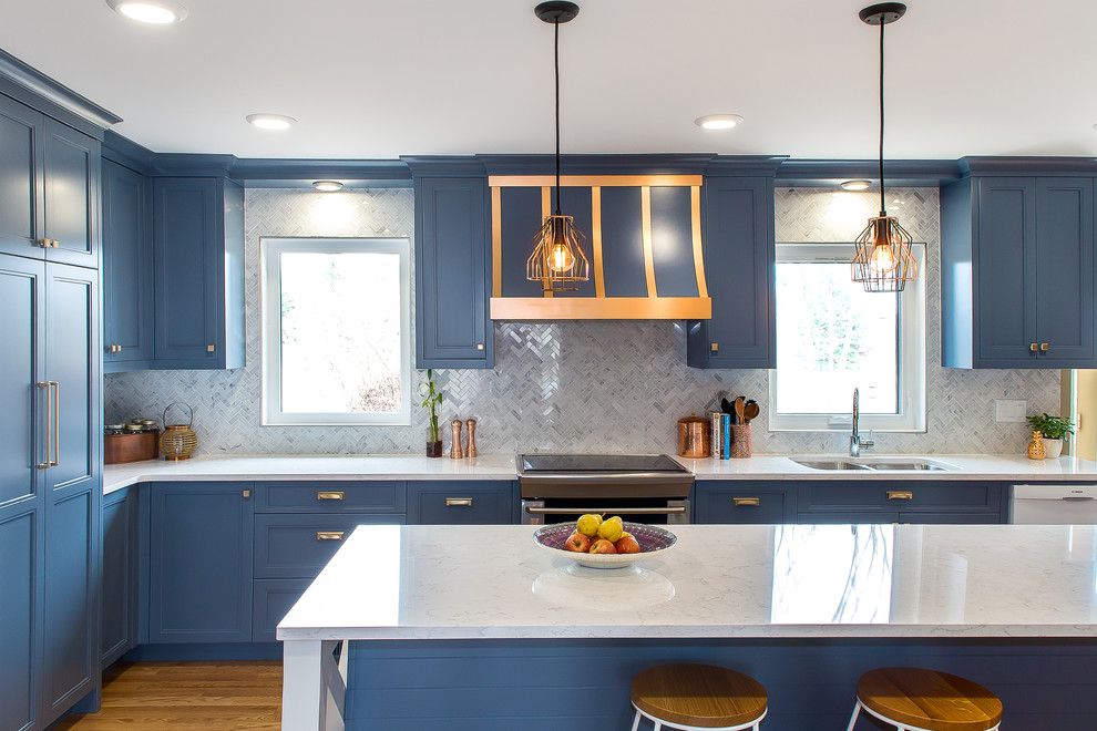 Idéer för ett avskilt, stort klassiskt l-kök, med en dubbel diskho, luckor med infälld panel, blå skåp, marmorbänkskiva, vitt stänkskydd, stänkskydd i marmor, rostfria vitvaror, mellanmörkt trägolv, en köksö och brunt golv