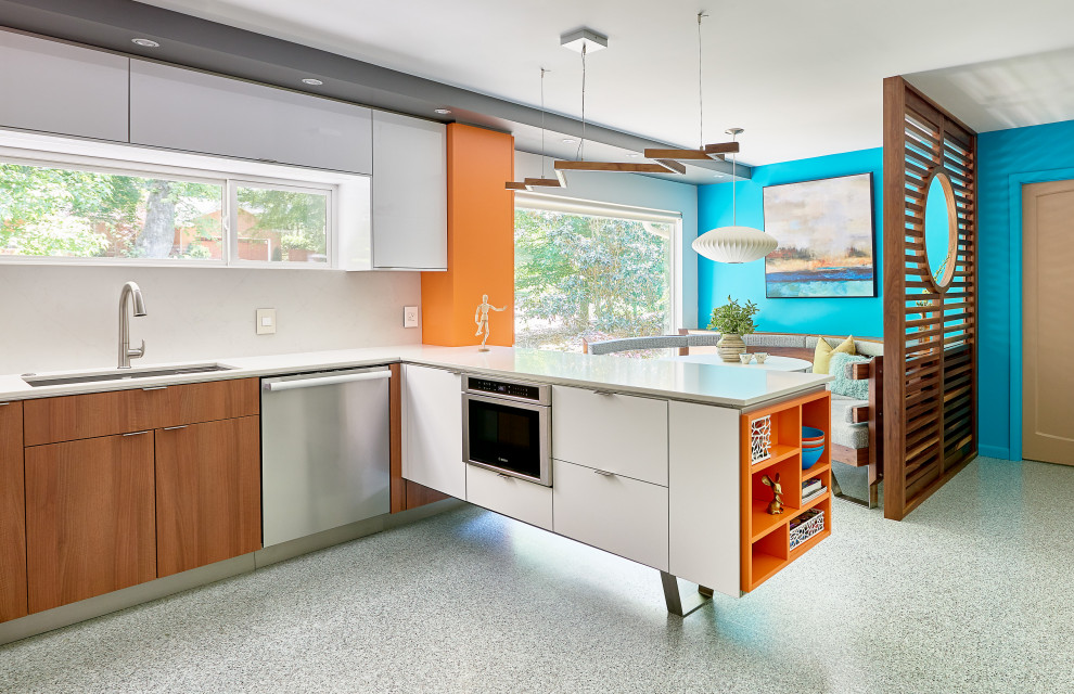 Inspiration for a mid-century modern u-shaped terrazzo floor and multicolored floor eat-in kitchen remodel in Charlotte with an undermount sink, flat-panel cabinets, medium tone wood cabinets, quartz countertops, white backsplash, quartz backsplash, white appliances and white countertops