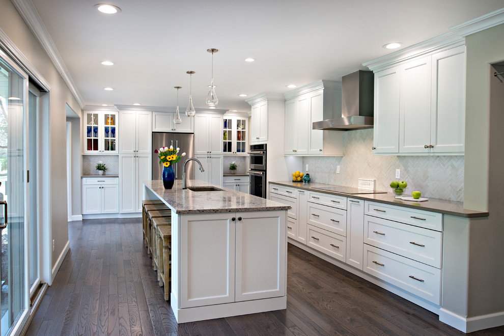 Large transitional l-shaped dark wood floor and brown floor eat-in kitchen photo in Detroit with an undermount sink, flat-panel cabinets, white cabinets, quartz countertops, beige backsplash, porcelain backsplash, stainless steel appliances, an island and multicolored countertops