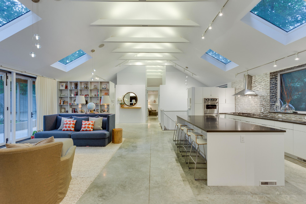 Example of a large trendy l-shaped concrete floor open concept kitchen design in DC Metro with flat-panel cabinets, white cabinets, marble countertops, multicolored backsplash, mosaic tile backsplash, stainless steel appliances and an island
