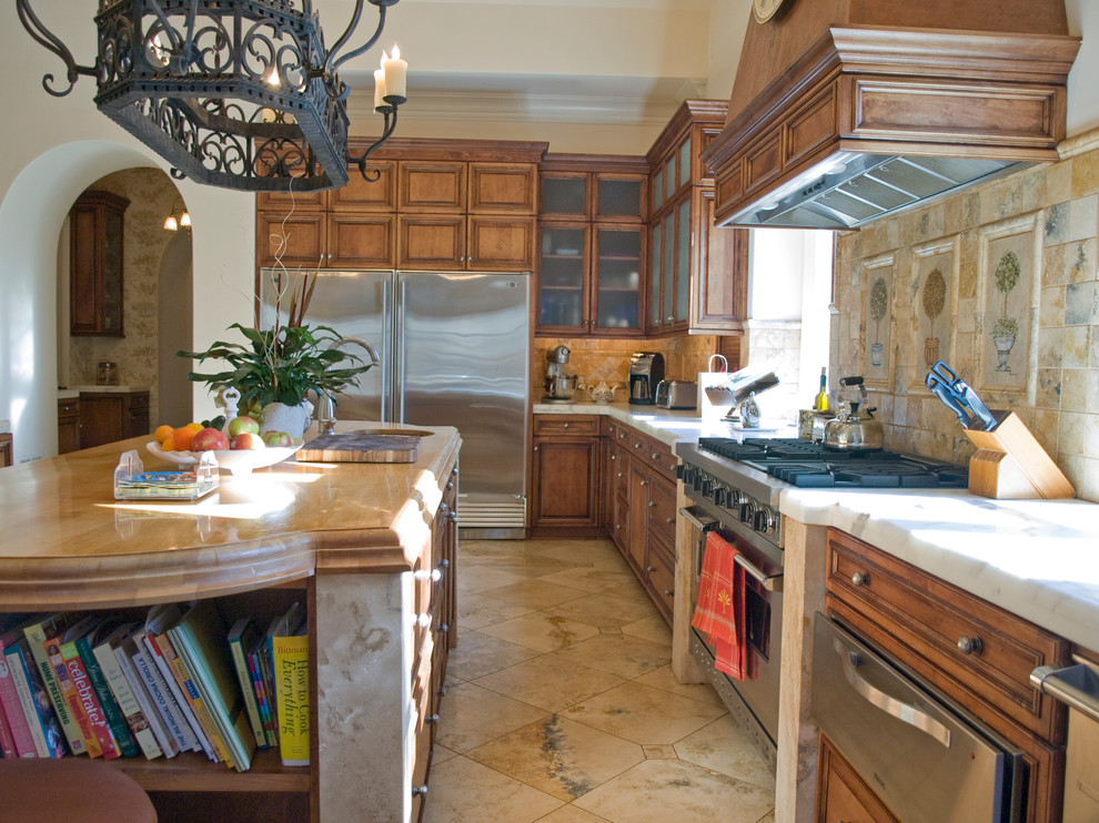 Inspiration for a timeless u-shaped eat-in kitchen remodel in Charlotte with an undermount sink, raised-panel cabinets, medium tone wood cabinets, multicolored backsplash, terra-cotta backsplash and stainless steel appliances