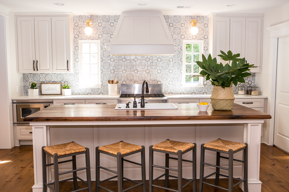 Mid-sized country galley medium tone wood floor and brown floor eat-in kitchen photo in Atlanta with shaker cabinets, gray cabinets, quartz countertops, blue backsplash, terra-cotta backsplash, stainless steel appliances, an island and a drop-in sink