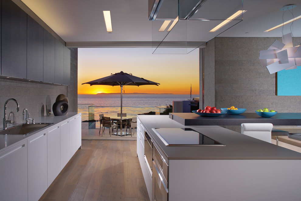 Inspiration for a contemporary kitchen remodel in Orange County with flat-panel cabinets, white cabinets and stainless steel appliances