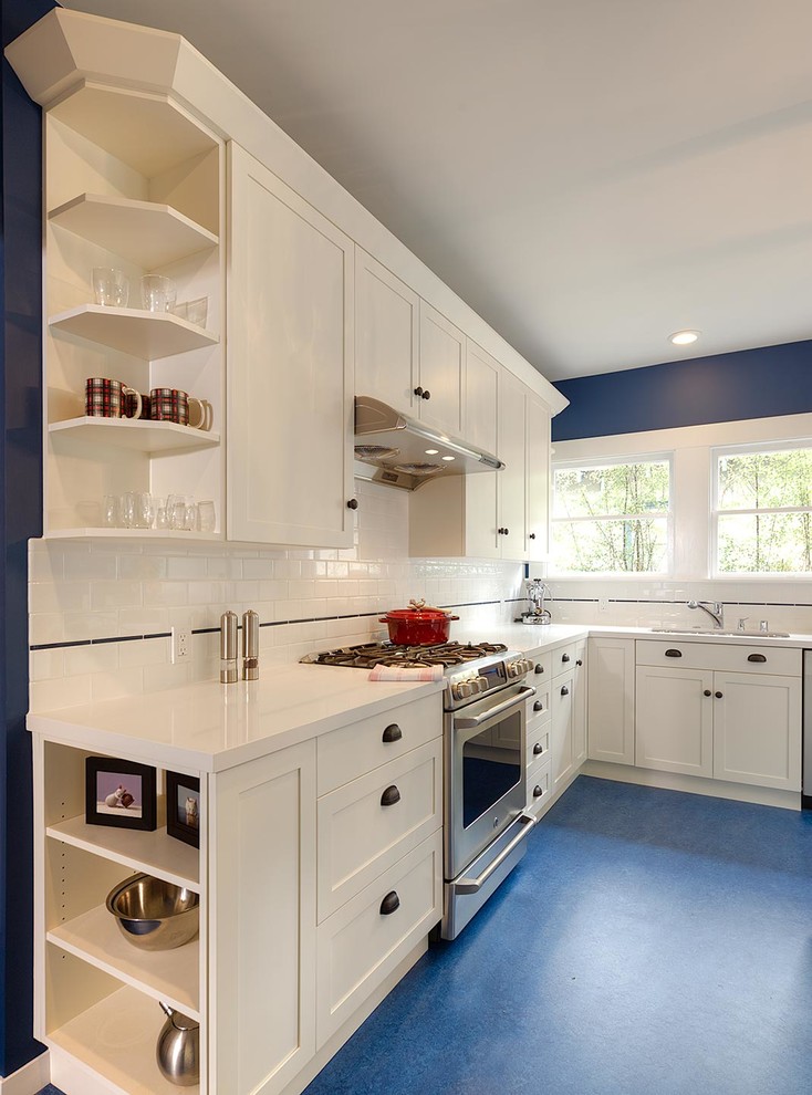 Photo of a medium sized traditional l-shaped enclosed kitchen in San Francisco with a submerged sink, shaker cabinets, white cabinets, engineered stone countertops, white splashback, ceramic splashback, stainless steel appliances, lino flooring and an island.