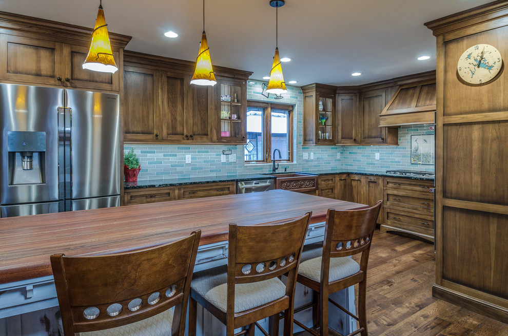 Large arts and crafts l-shaped dark wood floor eat-in kitchen photo in Philadelphia with a farmhouse sink, recessed-panel cabinets, medium tone wood cabinets, soapstone countertops, multicolored backsplash, ceramic backsplash, stainless steel appliances and an island