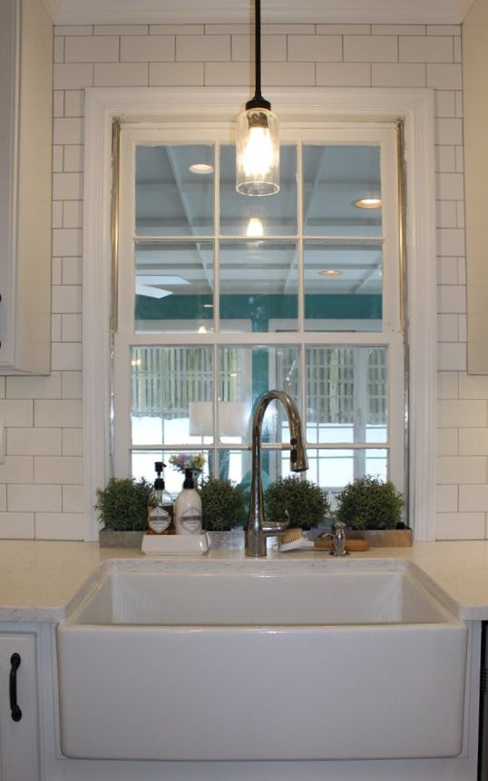 Foto på ett mellanstort vintage vit kök, med en rustik diskho, vita skåp, granitbänkskiva, vitt stänkskydd, stänkskydd i keramik, rostfria vitvaror, mellanmörkt trägolv och en köksö