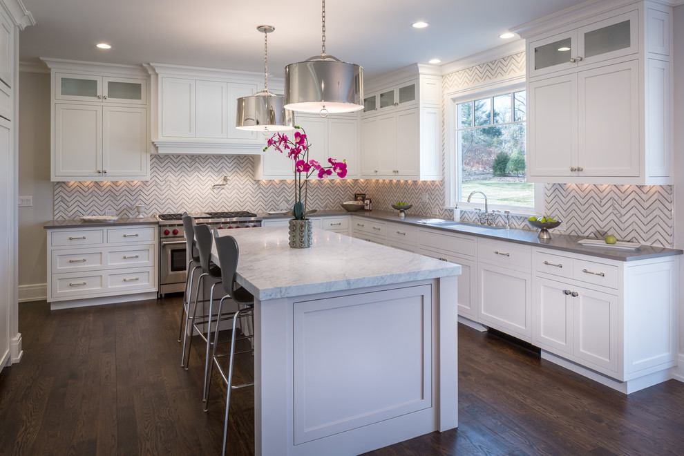 Transitional l-shaped dark wood floor kitchen photo in New York with an undermount sink, shaker cabinets, white cabinets, multicolored backsplash, stainless steel appliances, an island and gray countertops