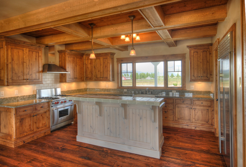 Inspiration for a mid-sized farmhouse u-shaped medium tone wood floor and brown floor open concept kitchen remodel in Other with a farmhouse sink, shaker cabinets, medium tone wood cabinets, granite countertops, stainless steel appliances and an island