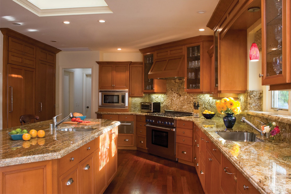 Example of a classic kitchen design in Los Angeles with paneled appliances, brown backsplash and stone slab backsplash
