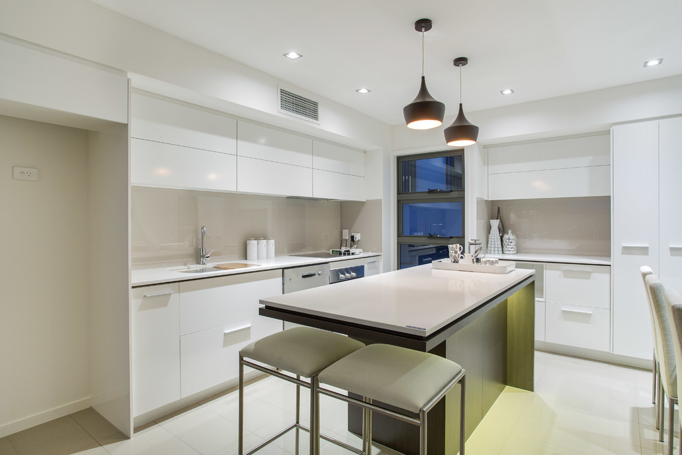 Example of a trendy eat-in kitchen design in Brisbane with flat-panel cabinets, white cabinets, gray backsplash and an island