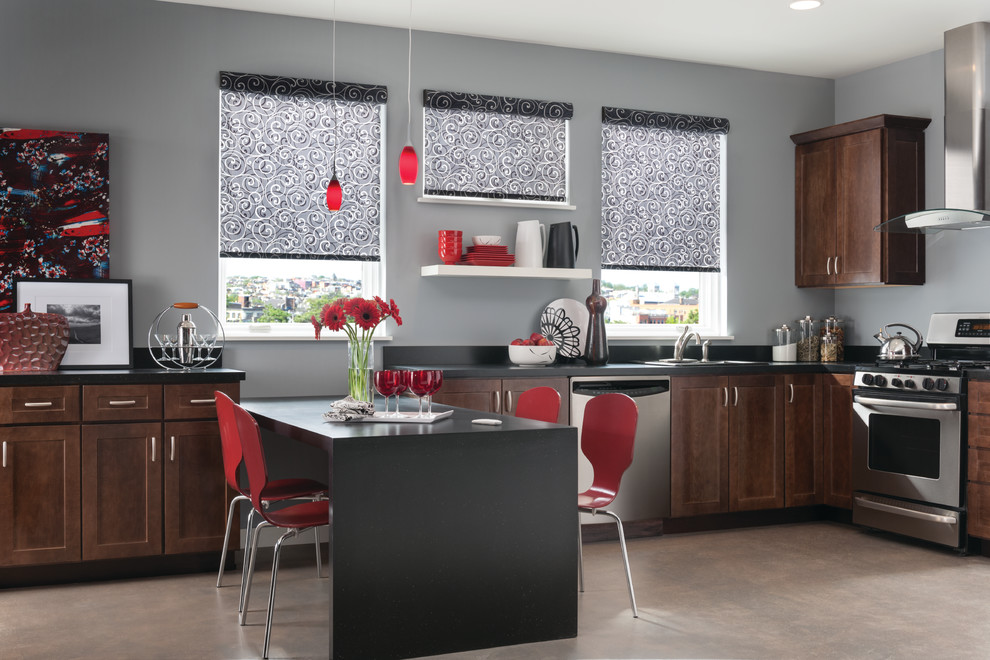 Large minimalist u-shaped concrete floor eat-in kitchen photo in New Orleans with a drop-in sink, shaker cabinets, medium tone wood cabinets, solid surface countertops, black backsplash, stone slab backsplash, stainless steel appliances and a peninsula