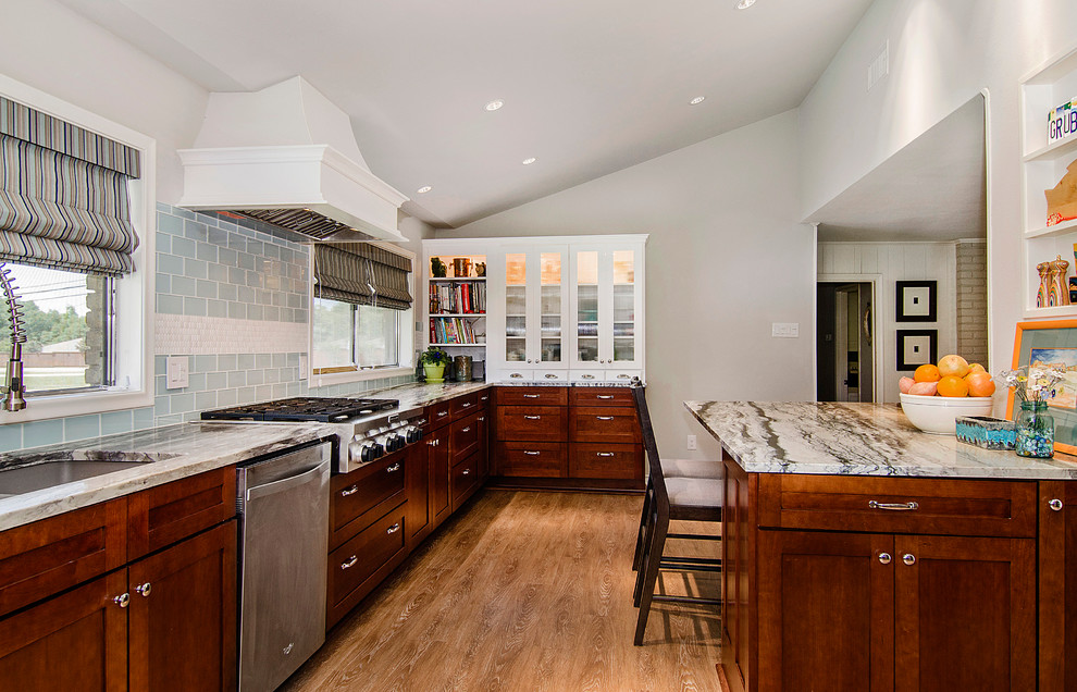 Example of a mid-sized transitional u-shaped vinyl floor eat-in kitchen design in Dallas with an undermount sink, shaker cabinets, medium tone wood cabinets, quartzite countertops, blue backsplash, glass tile backsplash, stainless steel appliances and an island