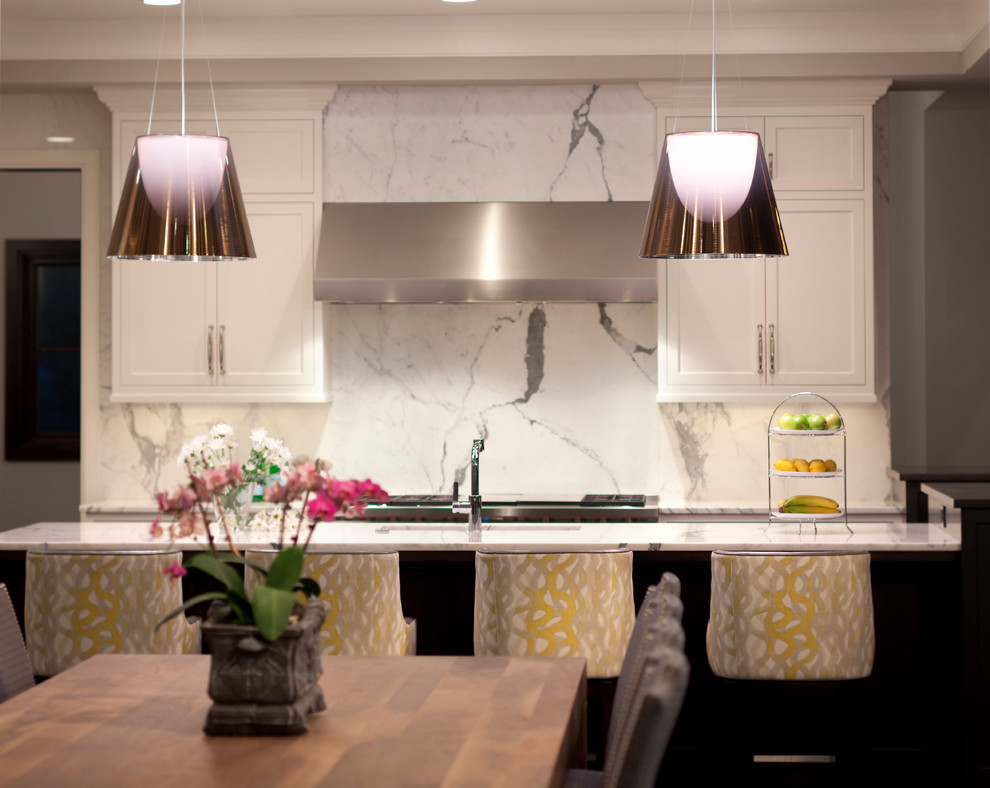 Example of a transitional dark wood floor kitchen design in Minneapolis with an undermount sink, white cabinets, marble countertops, white backsplash, stone slab backsplash, stainless steel appliances and an island